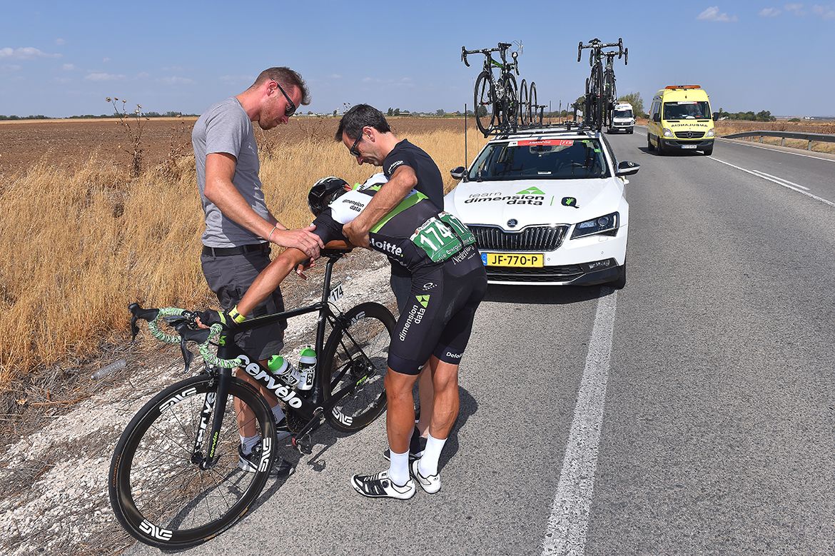 Omar Fraile climbs off after already vomiting earlier in the stage