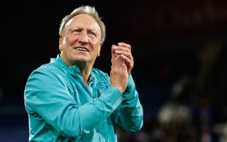 Neil Warnock applauding the Huddersfield Town supporters after his last match in charge of the club