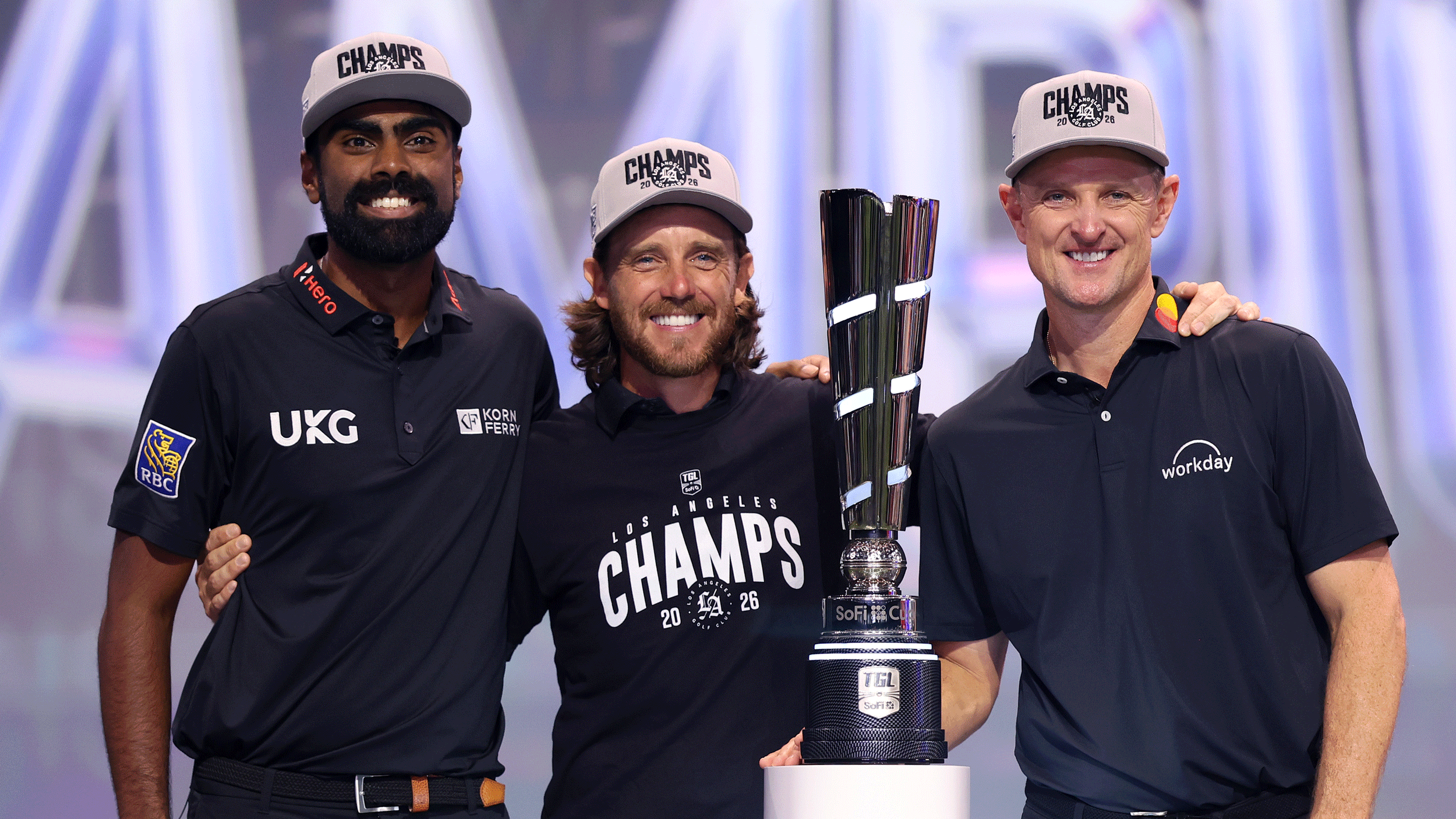 (L to R) Sahith Theegala, Tommy Fleetwood and Justin Rose pose with the SoFi Cup after their TGL 2026 victory
