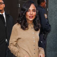 tessa thompson wears a beige cardigan.