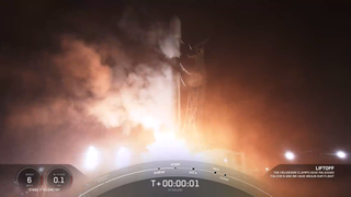 A white SpaceX rocket launches at night from launch pad