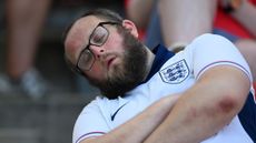 Man in England shirt asleep