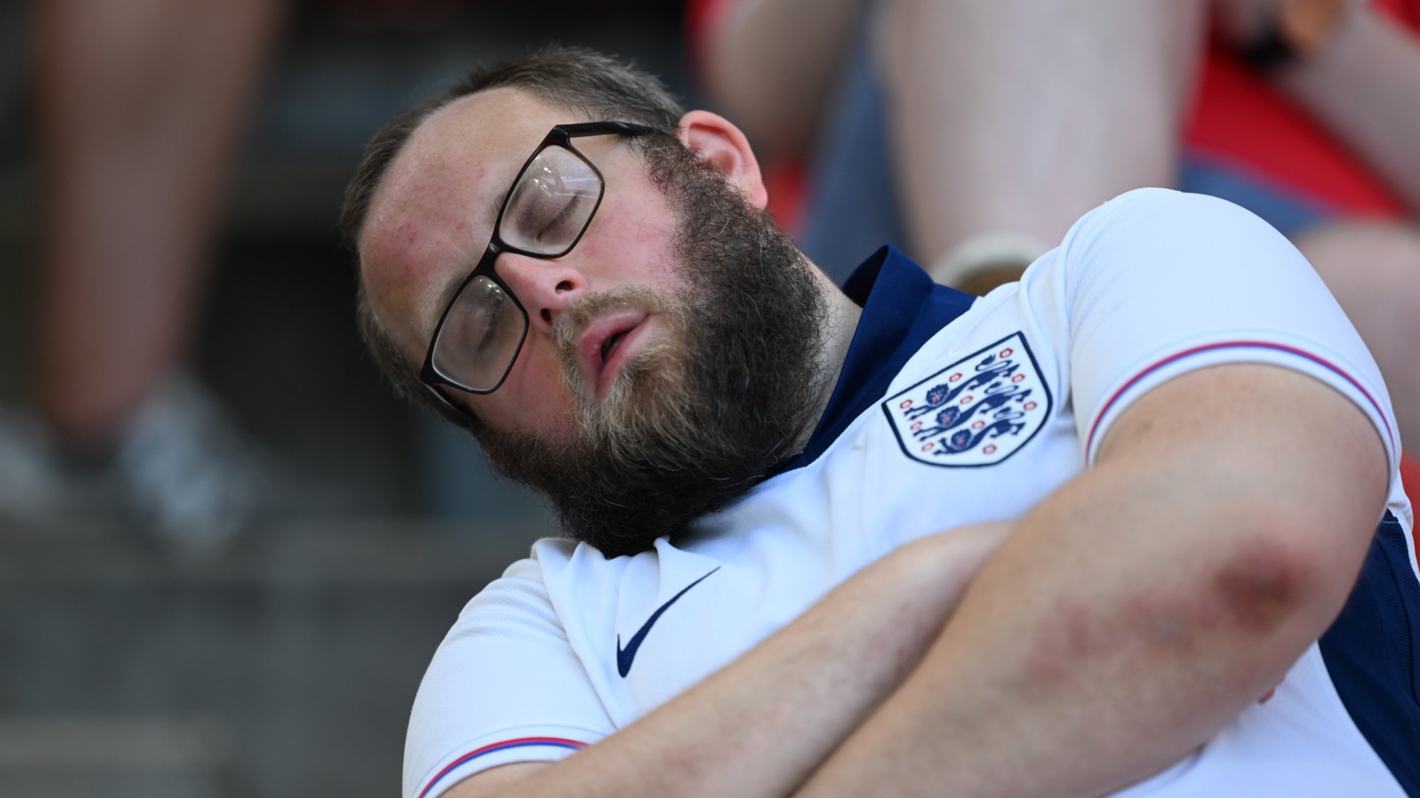 Man in England shirt asleep
