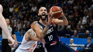 rance's captain Evan Fournier (C) gets past Poland's A.J. Slaughter ahead of the FIBA Basketball World Cup 2023.