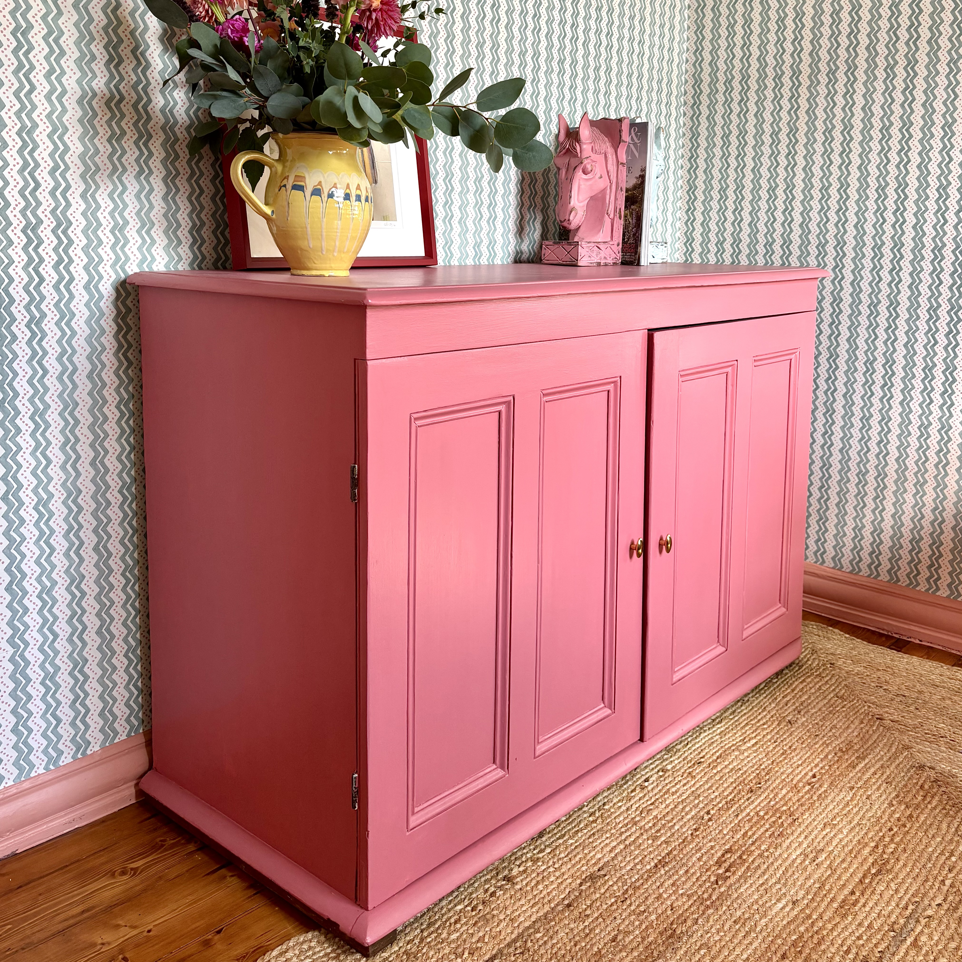 pink vintage cabinet with vintage jug on top