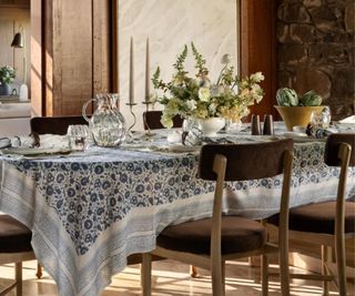 Dining table decorated with candles and a fruit bowl