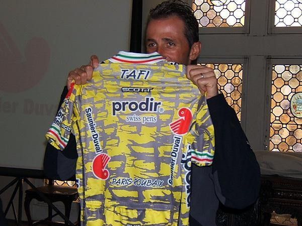 Andreaa Tafi holds up his special Paris-Roubaix jersey with pav&eacute;