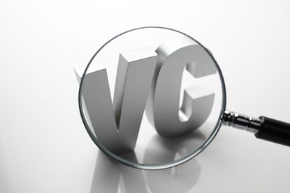 magnifying glass over letters V and C for venture capital
