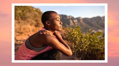 Young woman taking a break on a hiking trip looking at view