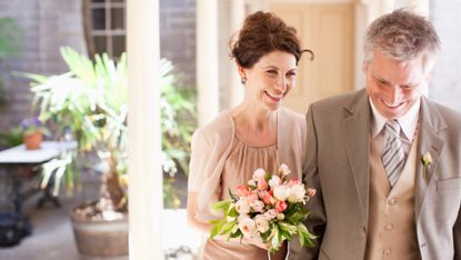 Mature bride and groom smiling
