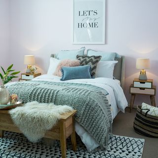 bedroom with white wall and bed with pillows