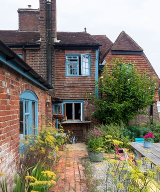 Red brick exterior of Grade II listed farmhouse in Sussex