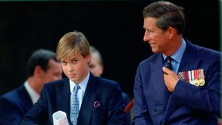 Prince Charles talking to his son, Prince William