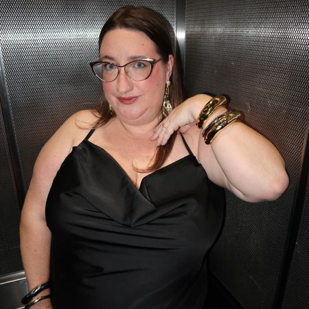 Sarah Chiwaya wearing a little black dress with mixed metal jewelry