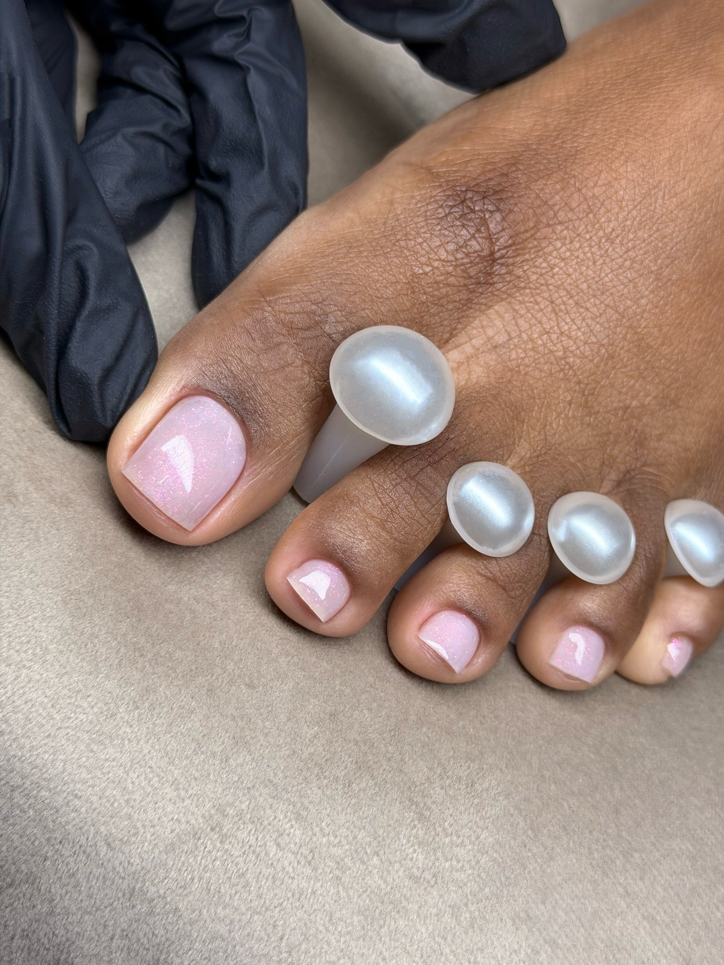 A shimmery pink pedicure