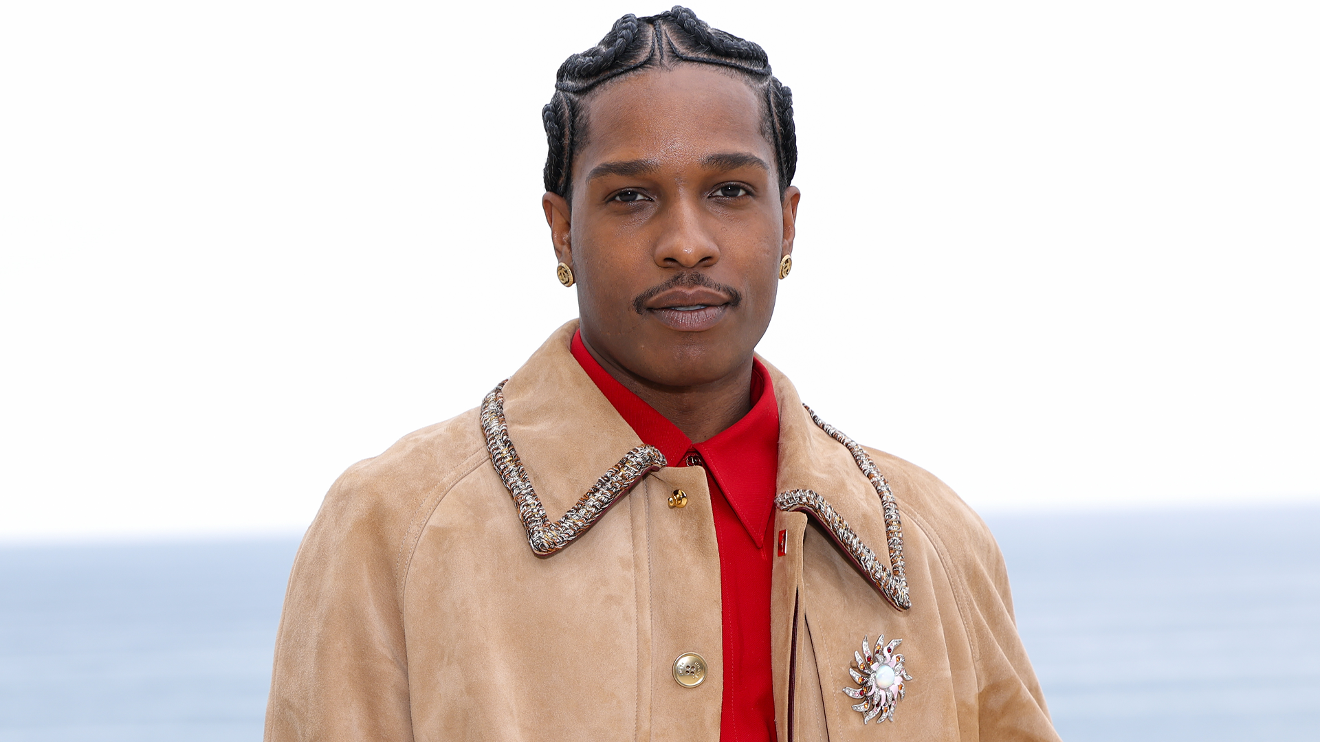 A$AP Rocky attended the Chanel Cruise 2026 fashion show with a pink Chanel Flap bag and a girl dad bag charm