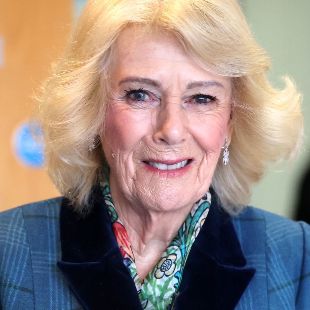Queen Camilla wears a blue coat and floral scarf