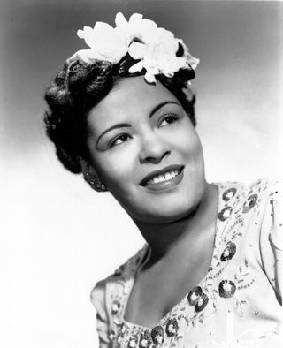 Billie Holiday poses for a portrait in circa 1939 with a flower in her hair