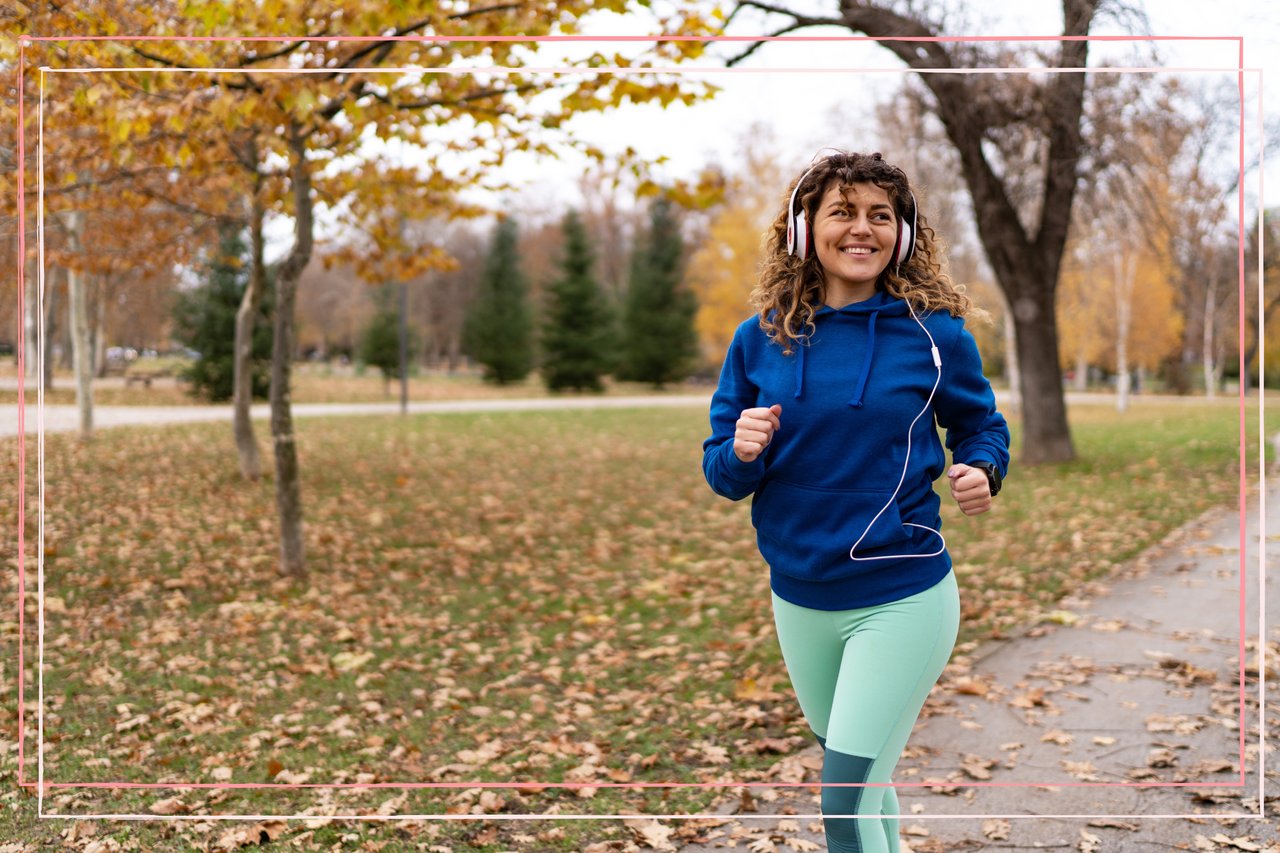 Woman running in the park in autumn