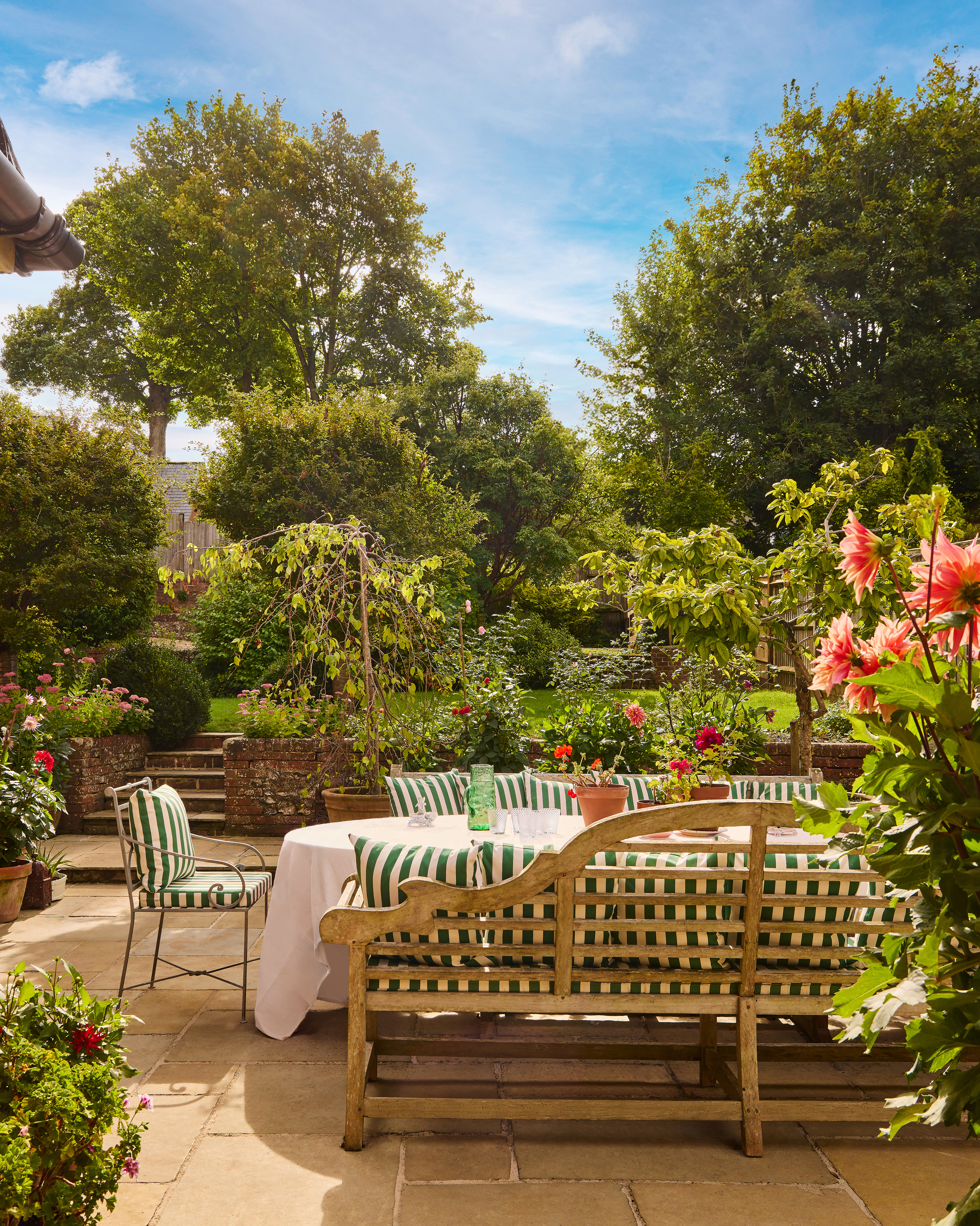 wooden bench with tablecloth dining table pinstripe chairs garden