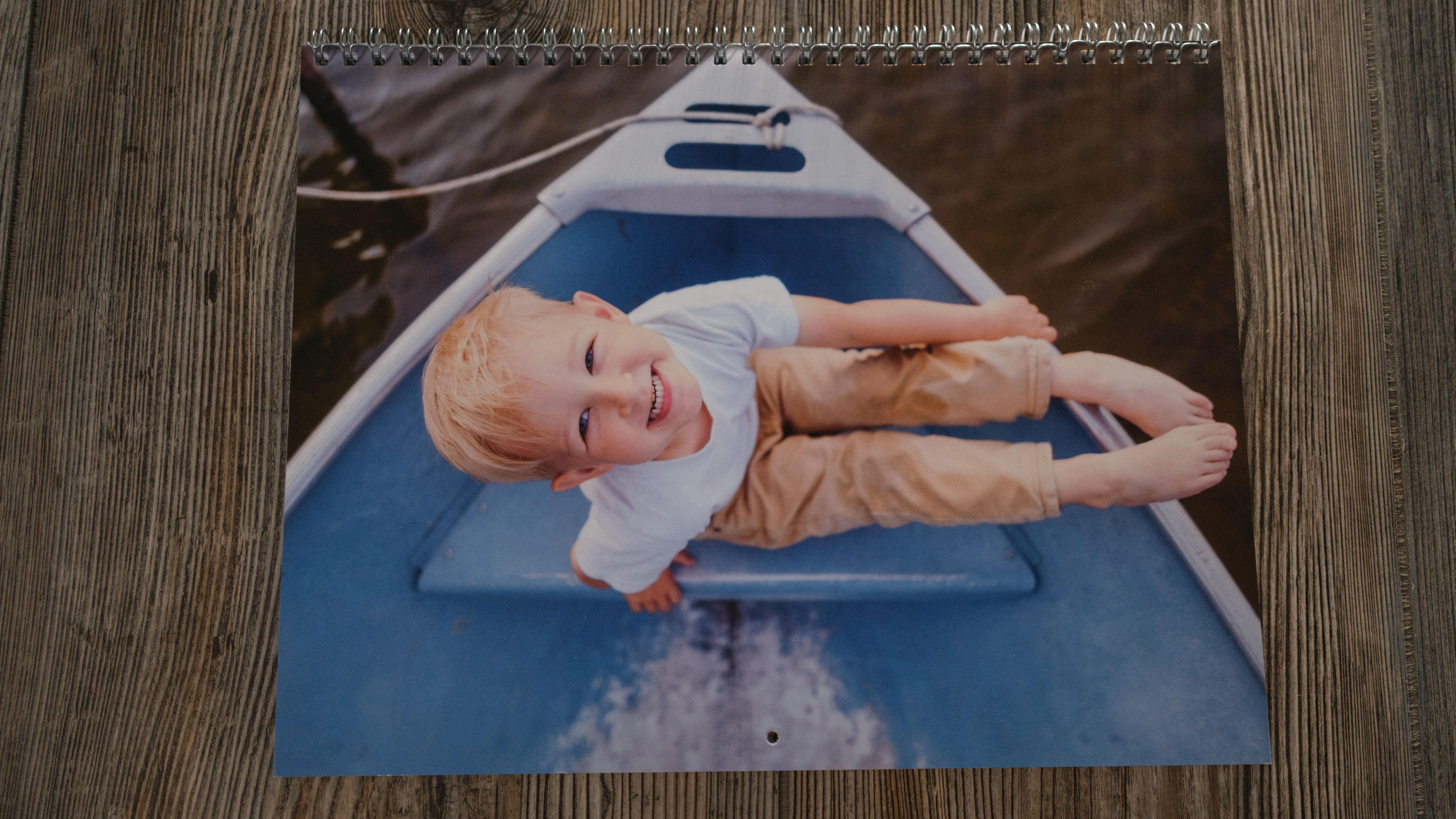 A photo calendar from Shutterfly on a wood background