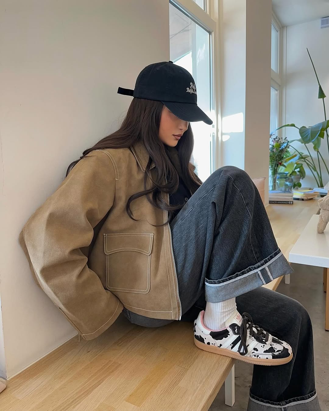 An influencer wearing cow print Sambas.