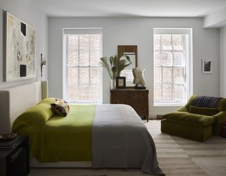 a bedroom with green bed linen