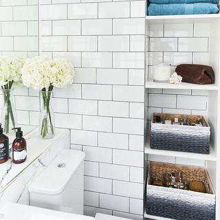 bathroom with shelves and white tiles