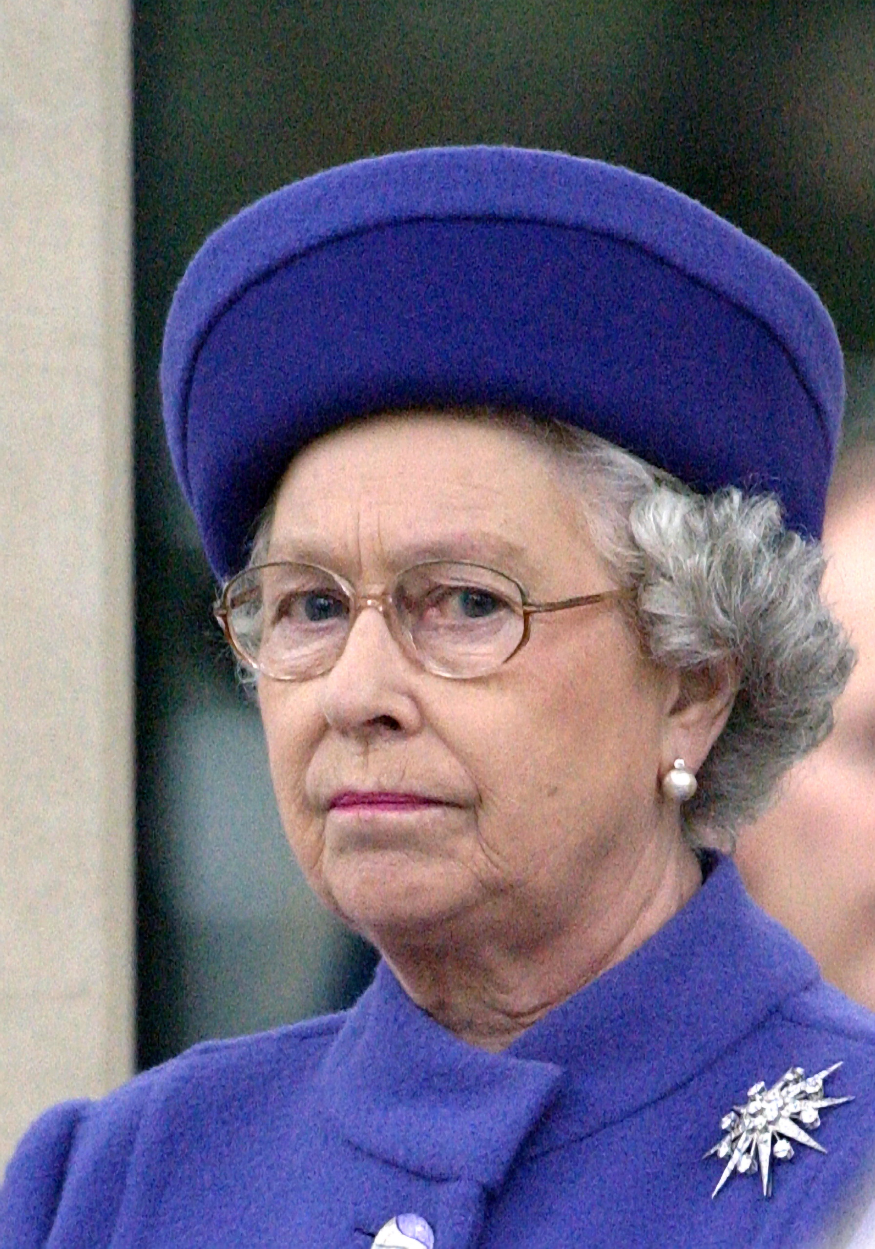 Queen Elizabeth wearing a blue coat and hat