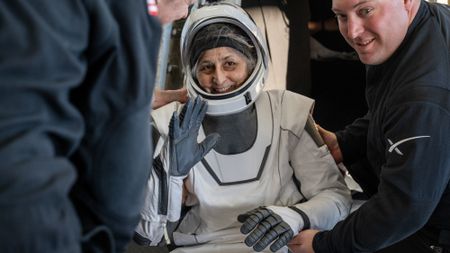 Nasa astronaut Suni Williams is helped out of a SpaceX Dragon spacecraft 