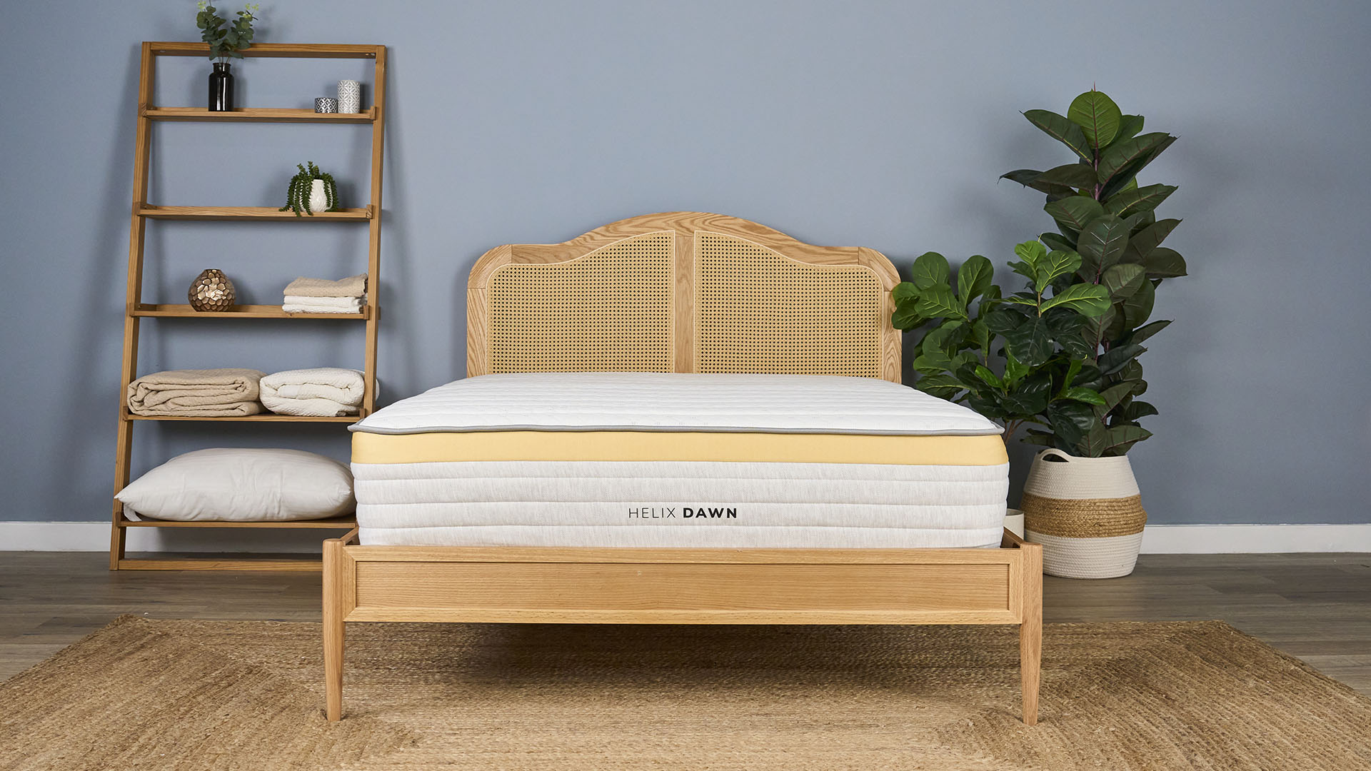 The Helix Dawn Mattress, a firm hybrid bed for stomach sleepers and back sleepers, placed on a bed frame in a bedroom