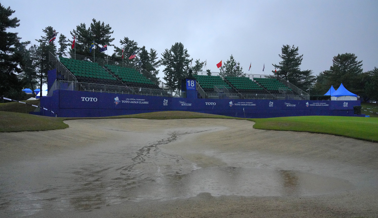 Water in a bunker and on the green at the Toto Japan Classic