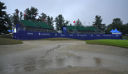 Water in a bunker and on the green at the Toto Japan Classic