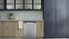 A smeg dishwasher in contemporary kitchen with black and blue cabinetry decor