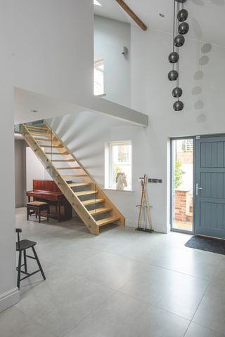 glass and wood modern staircase in renovated farmhouse
