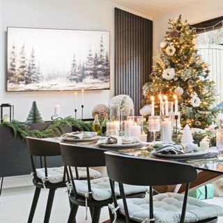 dining table with festive tablescape next to Christmas tree