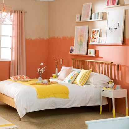 Orange bedroom with wooden bed