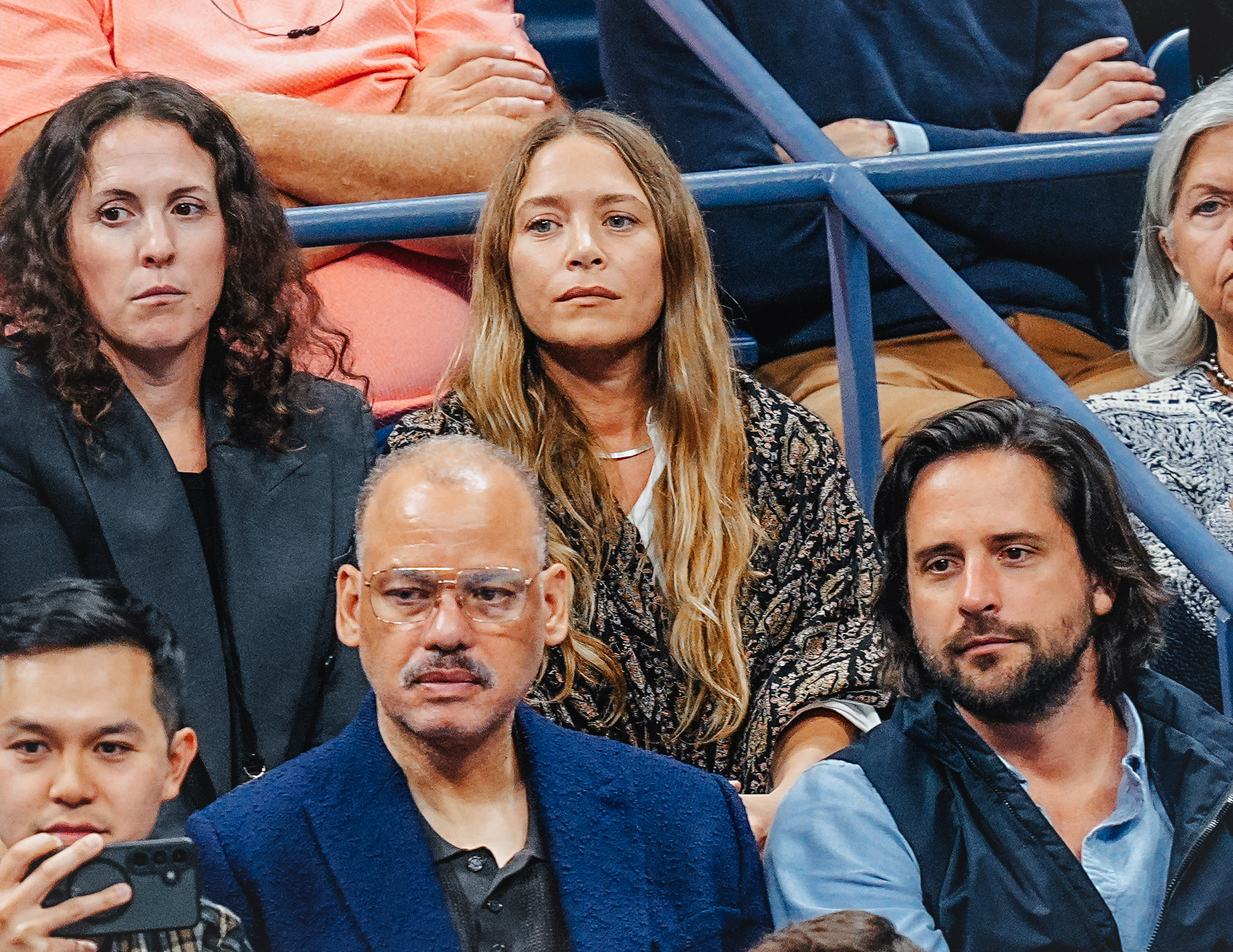 mary-kate olsen in a brocade coat and a crowd of people at the US Open