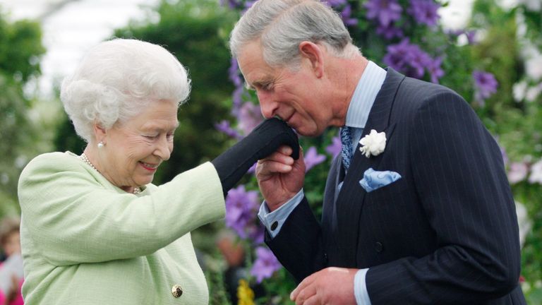 Prince Charles kisses Queen's hand