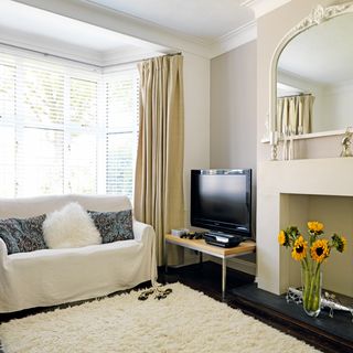 white living room with sofa and carpet on floor