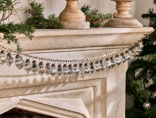 silver bauble garland hanging on fireplace