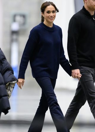 Meghan Markle wearing jeans and a jumper