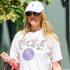 Jennifer Lawrence pulls off toe ring sandals with an all-white street style look in NYC.