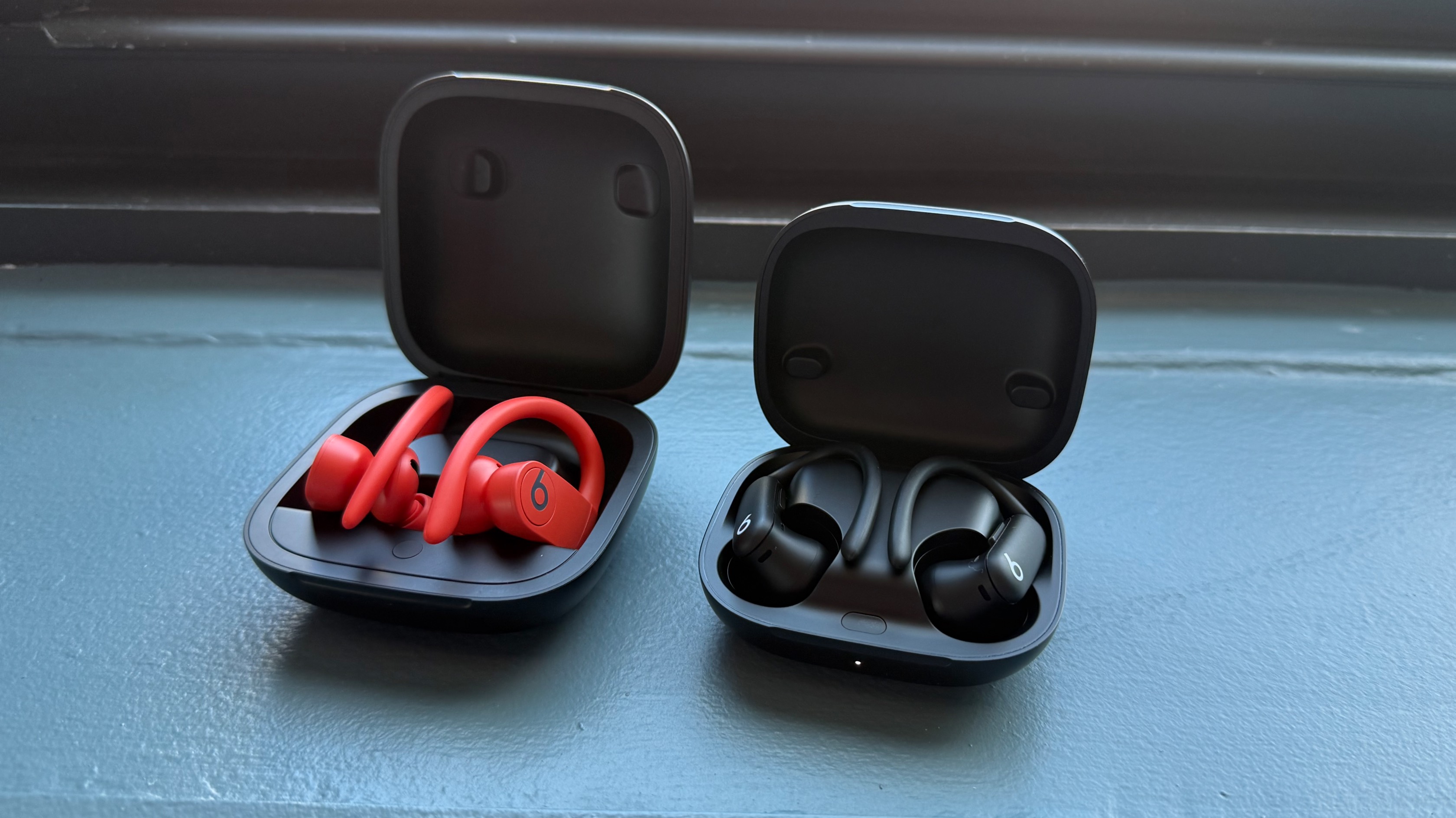 Powerbeats Pro next to Powerbeats Pro 2 (case open)