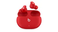 Beats Studio Buds earbuds and case, in red, on white background