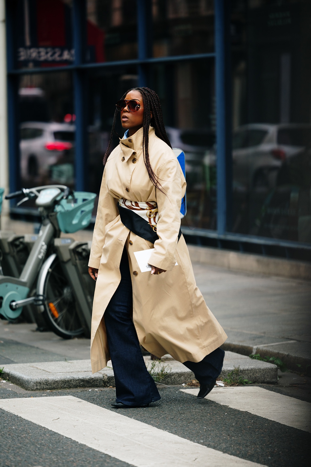 Woman wearing a chic trench coat outfit at Paris fashion week