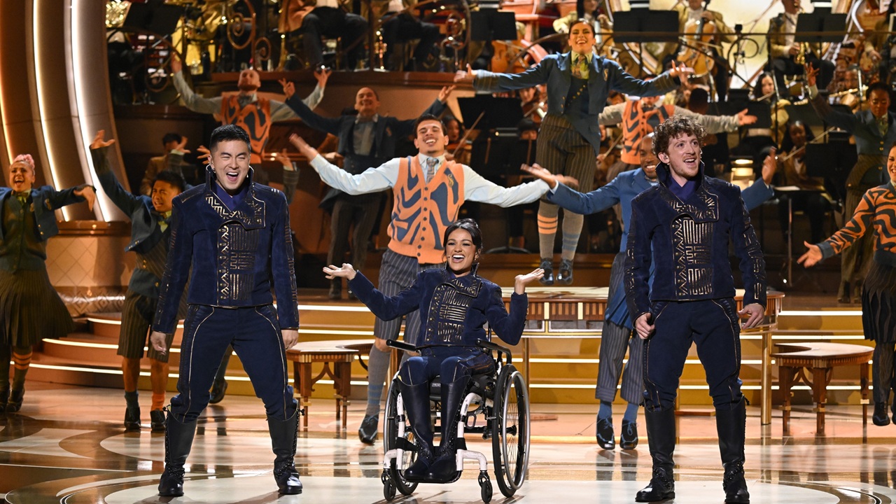 Left to right: Bowen Yang, Marissa Bode, and Ethan Slater performing "Dancing Through Life" onstage at the Dolby Theatre in LA for NBC's "Wicked: One Wonderful Night" event.