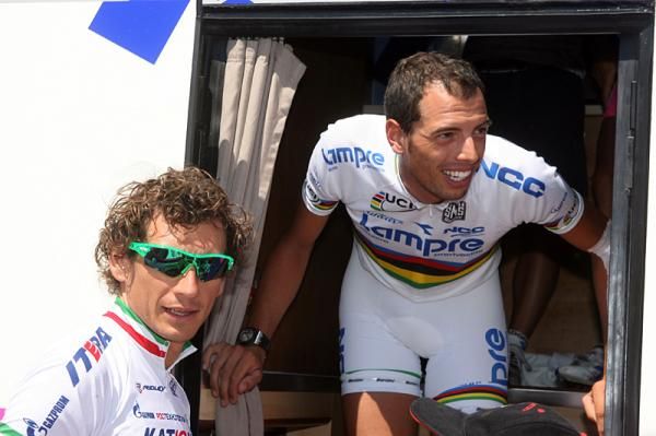 Alessandro Ballan emerges from the team bus, greeted by Filippo Pozzato.
