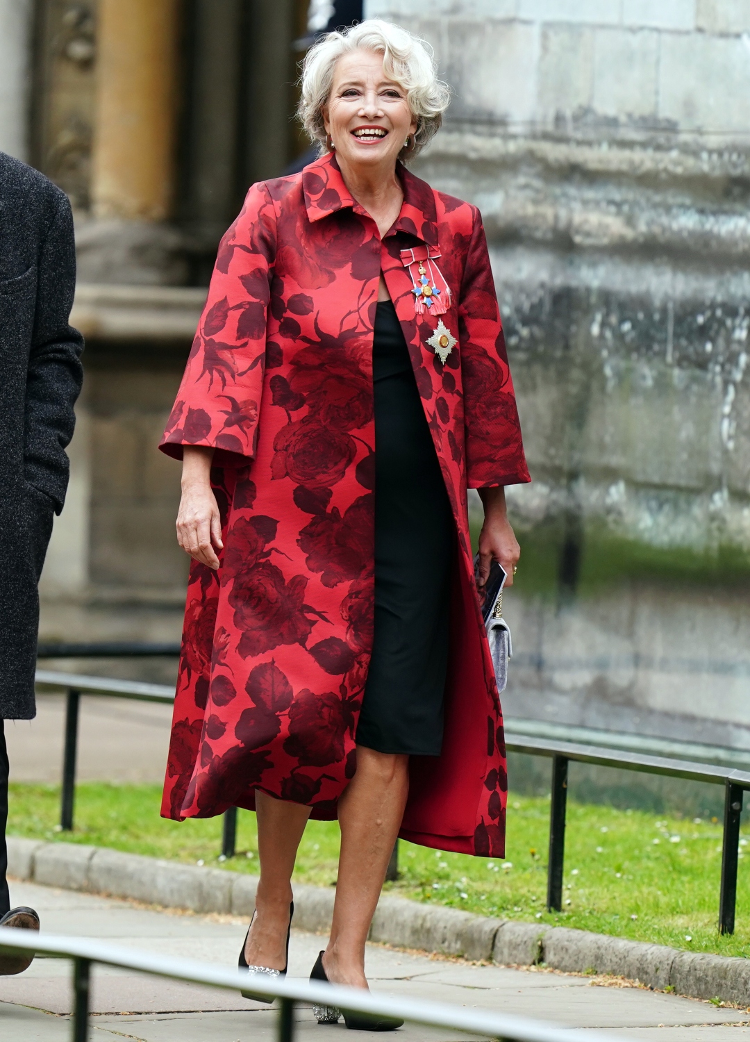 Emma Thompson wearing red coat