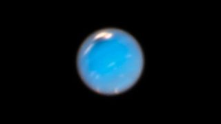 A Hubble image based on photographs taken in September and November shows a dark storm on Neptune.